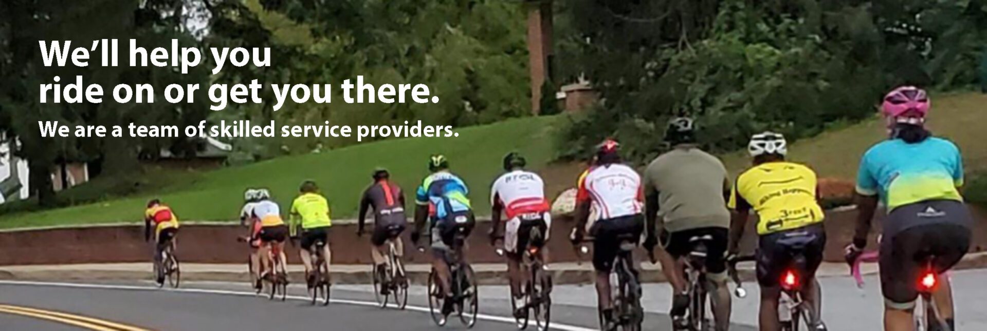 A group of people riding bikes down the street.